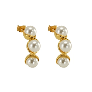 Detailed view of three white pearls set in a golden S-shaped stainless steel earring