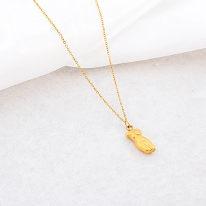 Minimalist 18K gold plated stainless steel necklace featuring a female torso pendant on white cloth
