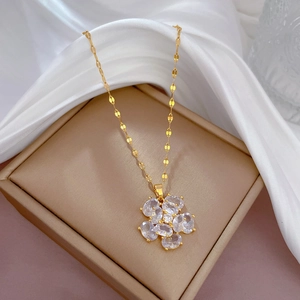 Titanium steel gold floral necklace with oval sparkling zircons on soft white silk