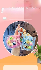 Close-up of rotating fishing game keychain with cute cartoon figures in pink and blue