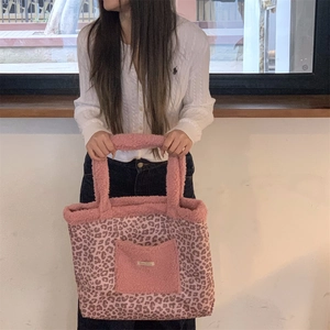 Detailed shot of pink leopard print tote bag with soft sherpa trim and front pocket
