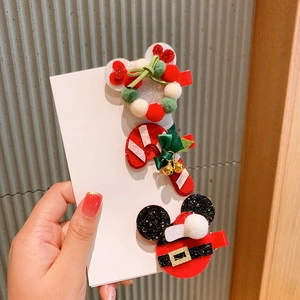 Close-up of Christmas hair clips with Mickey-shaped Santa and reindeer antler details