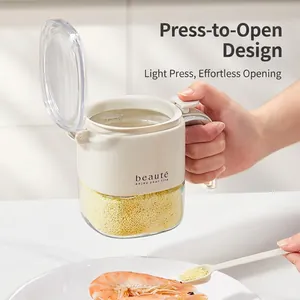 Kitchen glass seasoning jar with white press-open lid and spoon for salt and spices