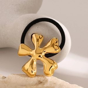 Elegant gold metal flower hair tie with high-elastic black cord on stone display