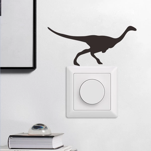 Detail of black dinosaur silhouette vinyl wall sticker above a white light switch