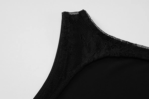 Detailed close-up of intricate black lace trim and stitching on the dress neckline
