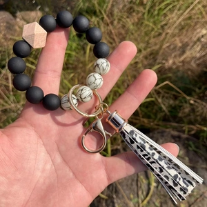 Detail of marble pattern beads and black leather tassel on silicone bead keychain