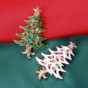 Detail of Christmas tree brooches in green and white with colorful inlaid rhinestones