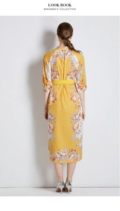 Back view of yellow floral midi dress with matching belt and three-quarter sleeves