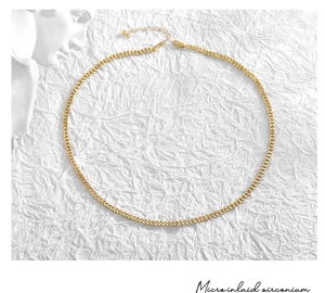 Detail of gold Cuban link necklace with adjustable extender chain and lobster clasp