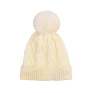 Detailed cable knit pattern on cream beanie with large faux fur pom-pom detail