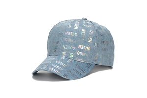 Detail of light blue denim baseball cap featuring rainbow laser QUEEN text pattern