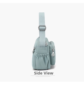 Side view of mint green nylon crossbody bag showing multiple pockets and wide strap
