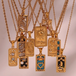 Detailed close-up of tarot card pendants with 18K gold plating and embossed motifs
