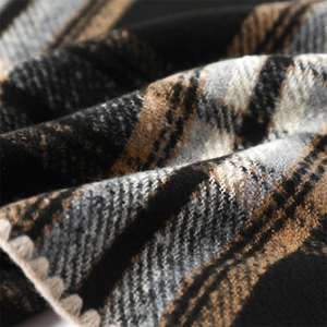 Macro detail of checkered scarf fabric showing soft texture and overlock stitch edges