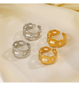 Detailed view of polished and hammered Cuban chain rings on champagne satin background