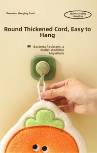 Close-up of thick round braided rope on coral fleece towel hanging on a green hook