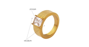 Macro detail of 18K gold-plated titanium ring featuring square-cut zircon and textured band