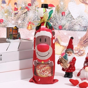 Detailed view of red knitted reindeer wine bottle cover with Warm Wishes text design