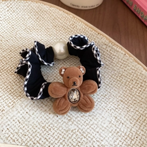 Detail of bear hair tie with brown flocking, rhinestone belly, and houndscut fabric