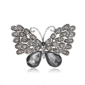 Macro detail of butterfly brooch with vintage silver metal and dark grey crystals