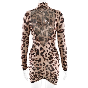 Detail of leopard print mini dress featuring backless cutout and ruched bodycon design