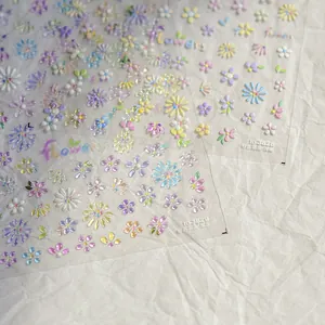 Detailed macro view of 5D embossed daisy flower nail art stickers in vibrant colors