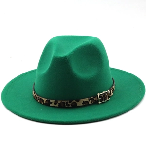 Detail of green fedora hat featuring leopard print band and golden square metal buckle