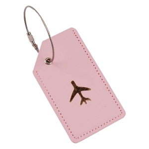 Detail of pink PU leather luggage tag with golden airplane and metal wire ring