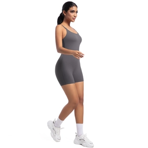 Side view of dark grey yoga romper for women paired with sneakers for fitness