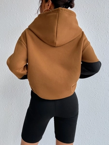 Women's oversized brown and black contrast color hoodie with long sleeves and large pocket