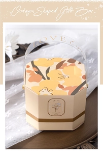 Detail of octagonal cream gift box with yellow floral patterns and PVC LOVE handle