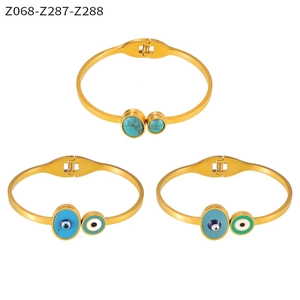 Detailed set of gold titanium bracelets with turquoise stone and evil eye enamel design