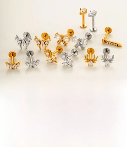 Close-up of titanium steel labret studs with spider and butterfly zircon designs