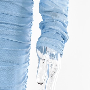 Detailed view of light blue mesh fabric with ruched texture on a sexy V-neck dress