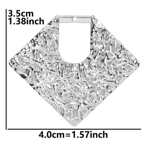 Macro view of geometric stainless steel diamond pendant with hammered texture details