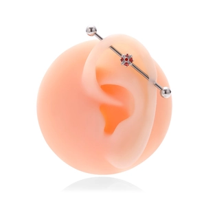 Silver industrial barbell earring with a red round stone and white zircon accents