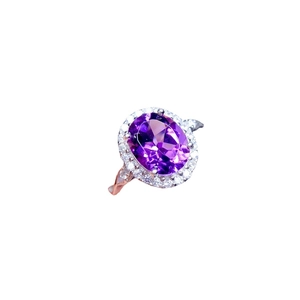 Elegant silver ring featuring an oval purple gemstone surrounded by sparkling white crystals