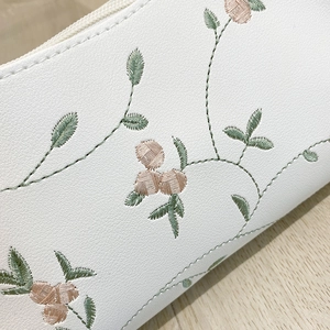 White PU leather shoulder bag with floral embroidery and litchi texture detail