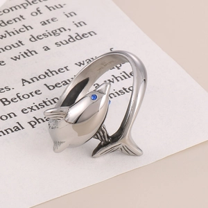 Detailed macro view of silver dolphin ring in 316L stainless steel with blue stone eye
