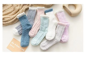 Close-up of cozy thick coral fleece socks in soft macaque colors with white plush cuffs