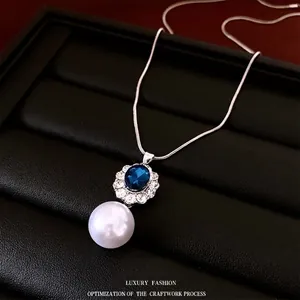 French vintage jewelry set with blue oval gemstone, pearl pendant and silver chain