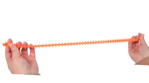 Close-up showing the elasticity and flexibility of the orange TPR dinosaur fidget toy rope