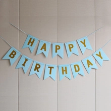Detail of blue swallowtail banner with gold foil Happy Birthday letters for party decor