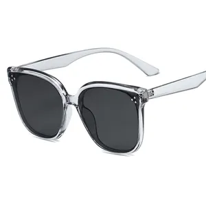 Modern oversized square sunglasses with transparent frames and grey lenses in a 45-degree view