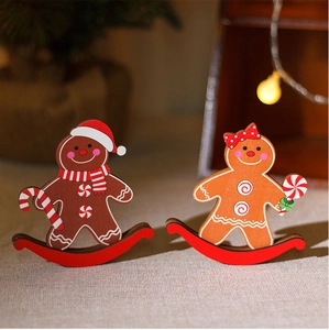Detail of wooden gingerbread man couple ornaments with red rocking base for Christmas decor