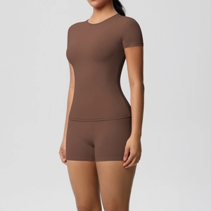 Detailed close-up of brown two-piece yoga set showing slim fit T-shirt and high waist shorts