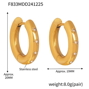Macro view of gold stainless steel hoop earrings with star-set zircon, 20mm diameter
