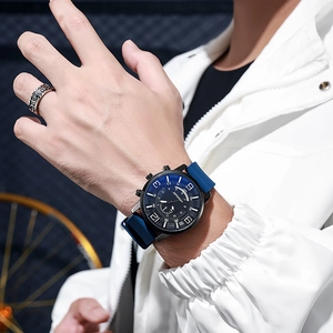 Men's fashion quartz watch with blue silicone strap and black dial worn by male model