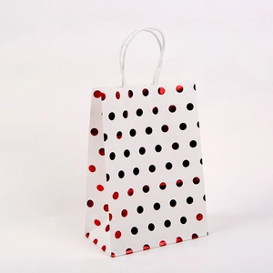 Premium white kraft gift bag with black and metallic red polka dots and paper handles